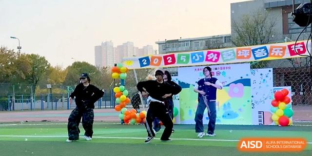 Students in black outfits showcase a high-energy hip-hop dance performance during a school festival at Tianjin Foreign Languages School.