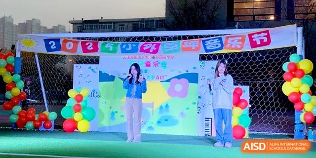 Two students perform a vocal duet on a decorated stage during the 2025 music event at Tianjin Foreign Languages School.