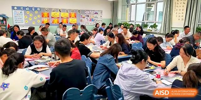 Parents and teachers attend an indoor meeting in a decorated classroom to discuss student progress at Urumqi Bayi High School.