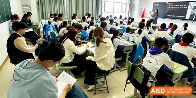 Students work in small groups at their desks during a collaborative classroom lesson at Urumqi Bayi High School.