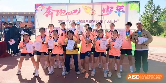 A team of students in orange jerseys proudly displays their certificates after a sports event at Urumqi Bayi High School.