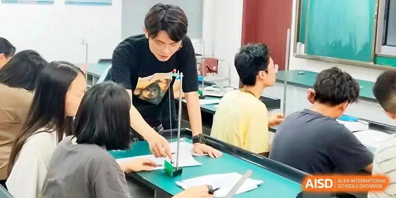 Students work together on a science experiment involving lab equipment on a specialized classroom desk at Wuhan Guanggu Future School.