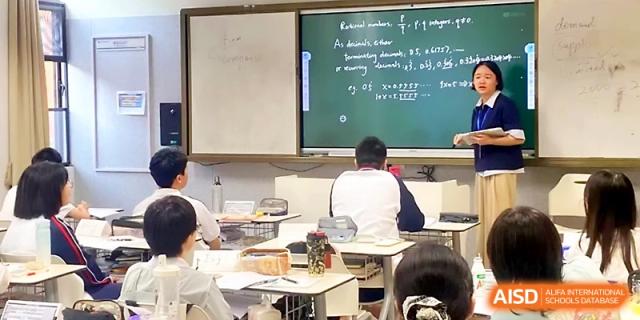 A classroom view shows a teacher using a green chalkboard to solve complex mathematical equations for students at Wuhan Guanggu Future School.