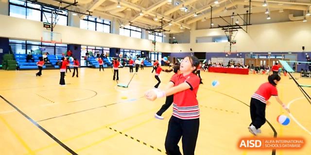 Students play an active game on the indoor basketball court during a physical education session at Yung Wing School Zhuhai.