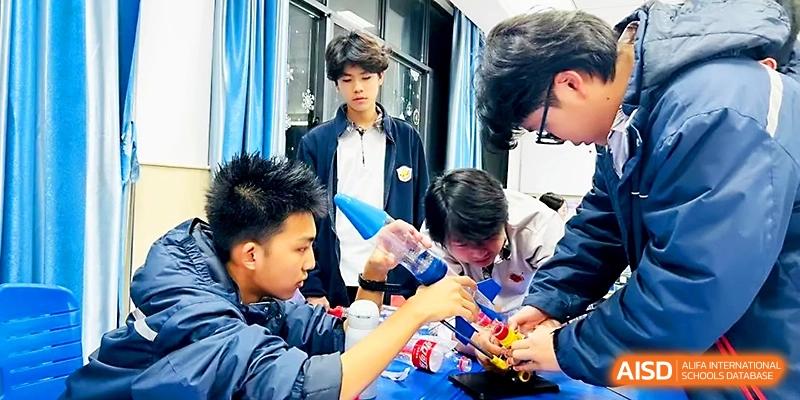Students work together using plastic bottles and various materials for a hands-on lab project at Zhangjiagang Foreign Language School.