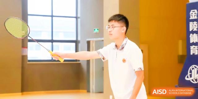 A student athlete stands ready on the court, holding a sports accessory during a physical education class at Zhangjiagang Foreign Language School.
