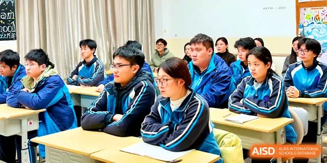 Attentive students in blue track jackets sit at their desks, focusing on a lesson during a classroom session at Zhengzhou No.19 High School.