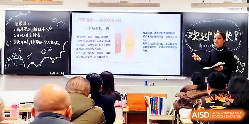 A digital display shows a detailed educational presentation while students take notes in the foreground at Zhengzhou No.19 High School.