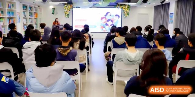 A group of students sitting in chairs and watching a presentation on a large screen at Beijing Financial Street Runze School