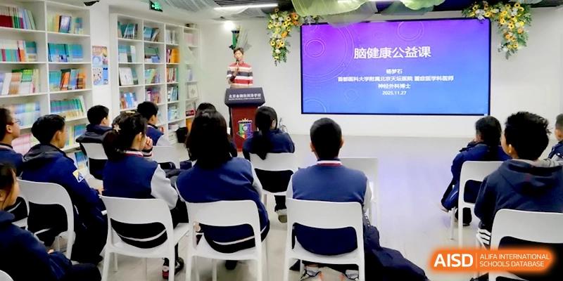 Students seated in a classroom while a teacher presents information on a purple screen at Beijing Financial Street Runze School