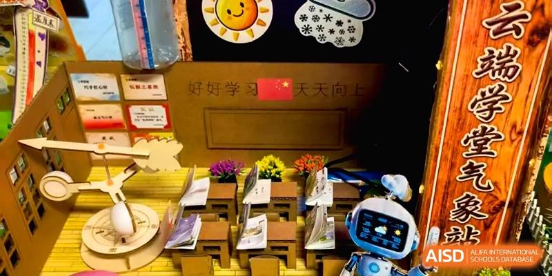 A classroom display featuring miniature desks and a small robot model on a table at Beijing Financial Street Runze School