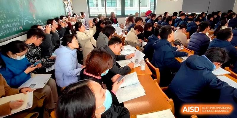 A large group of parents and educators sits attentively in a classroom during a parent-teacher meeting at Changzhou Senior High School of Jiangsu Province.