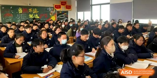 Students seated in a dense classroom setting focus on their textbooks and teacher during a lecture at Changzhou Senior High School of Jiangsu Province.
