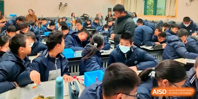 Students working together in a science lab environment discuss their findings during a practical session at Changzhou Senior High School of Jiangsu Province.