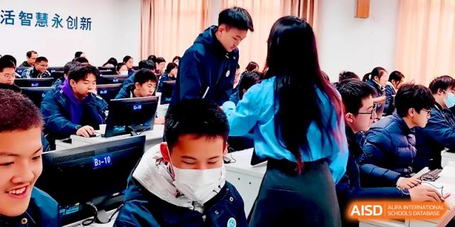 A teacher provides personalized guidance to a student working on a computer in a lab at Changzhou Senior High School of Jiangsu Province.