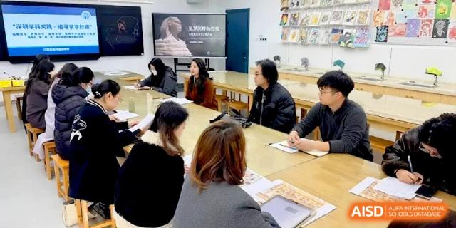 Staff members engage in a professional development meeting around a large conference table at Changzhou Senior High School of Jiangsu Province.