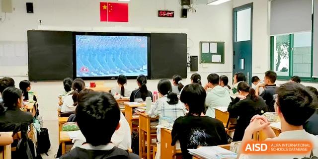 Students in a darkened room focus on a digital screen displaying educational content at Changzhou Senior High School of Jiangsu Province.
