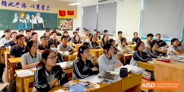 A crowded classroom of students in uniform focus on their work during an exam or study session at Changzhou Senior High School of Jiangsu Province.