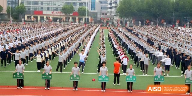 A massive formation of students performs synchronized calisthenics on the school’s track at Changzhou Senior High School of Jiangsu Province.