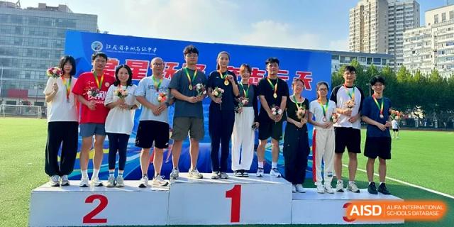 Student athletes stand on a winner's podium to receive their medals after a competition at Changzhou Senior High School of Jiangsu Province.