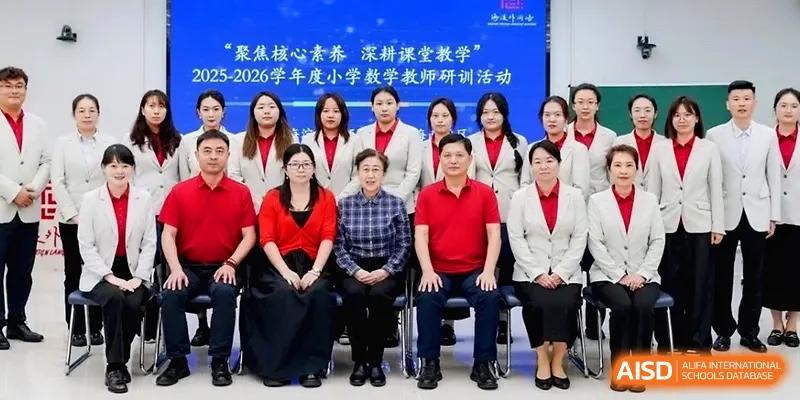 A large group of faculty members in matching red and white attire poses for a formal group portrait at Beijing Haidian Foreign Language Shi Yan School Hainan Campus.