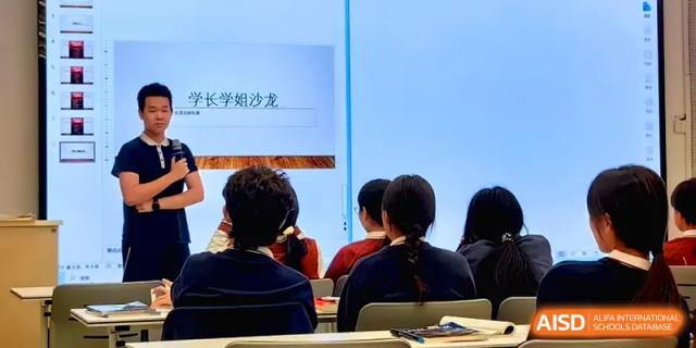 Students sit in a classroom observing a presentation on a screen during an academic session at Beijing Haidian Foreign Language Shi Yan School Hainan Campus.