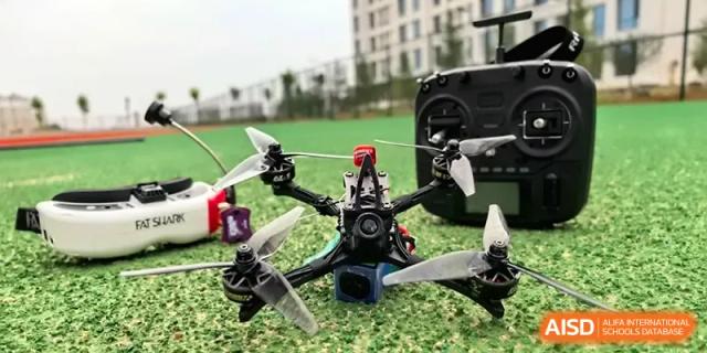 A high-tech drone sits on a grassy field ready for flight during a STEM activity at Beijing Haidian Foreign Language Shi Yan School Hainan Campus.
