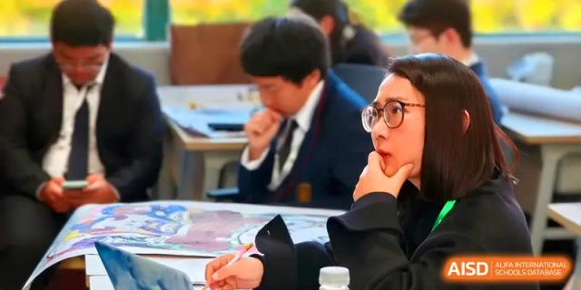 Students in formal school uniforms are deeply focused on writing and studying during a lesson at Zhengzhou No.11 High School.